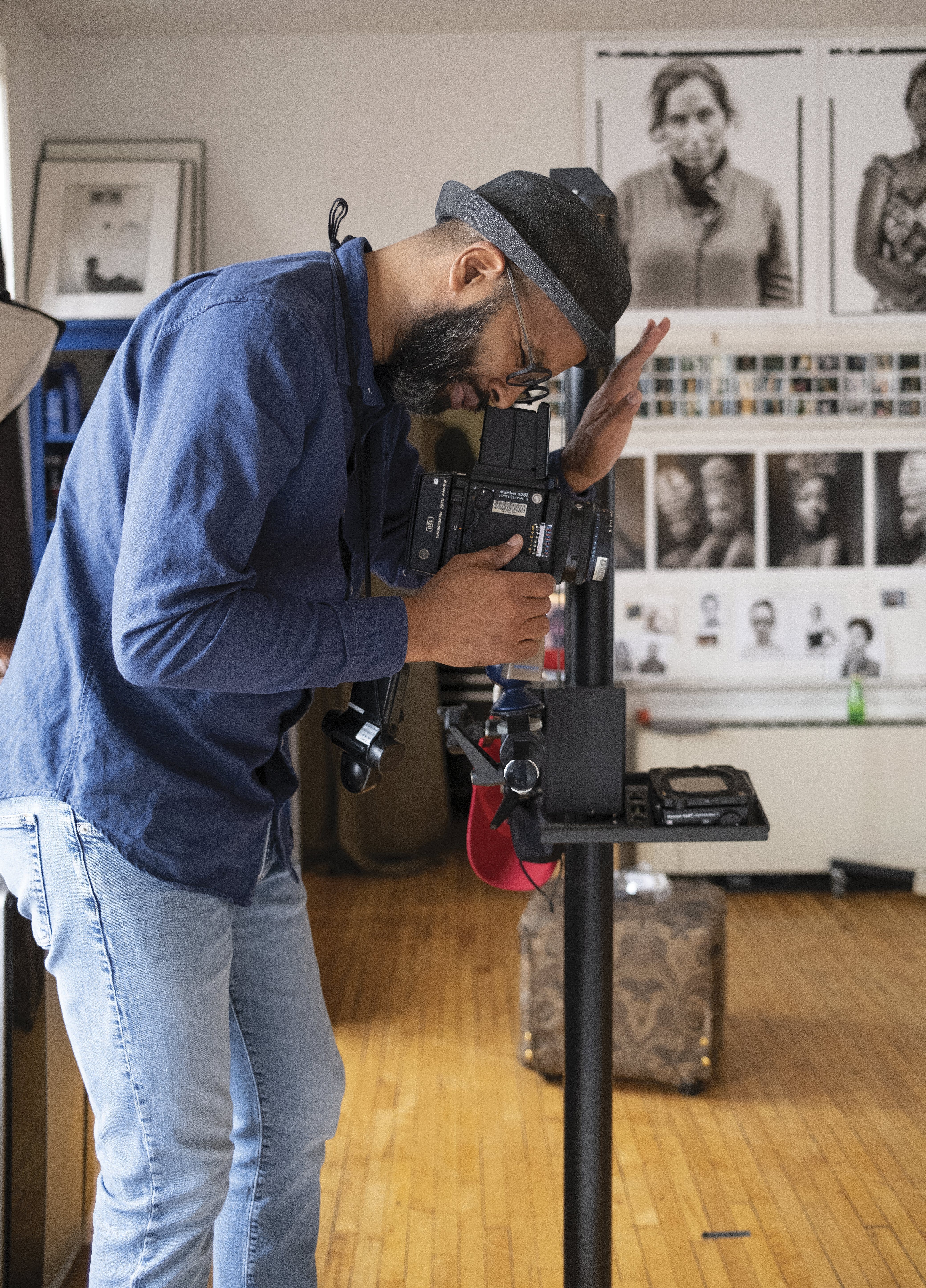 Photographer Tariq Tarey uses a classic medium-format film camera to photograph Papa Kalala in his studio. (Photo by Tim Johnson)